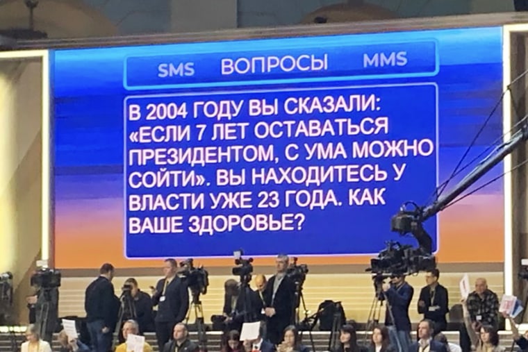 Questions from the general public are posed to Russia President Vladimir Putin via big screen during his televised appearance on Dec. 14, 2023.