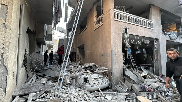 Palestinians survey the damage in Jabalia Camp in Gaza on Dec. 17, 2023.