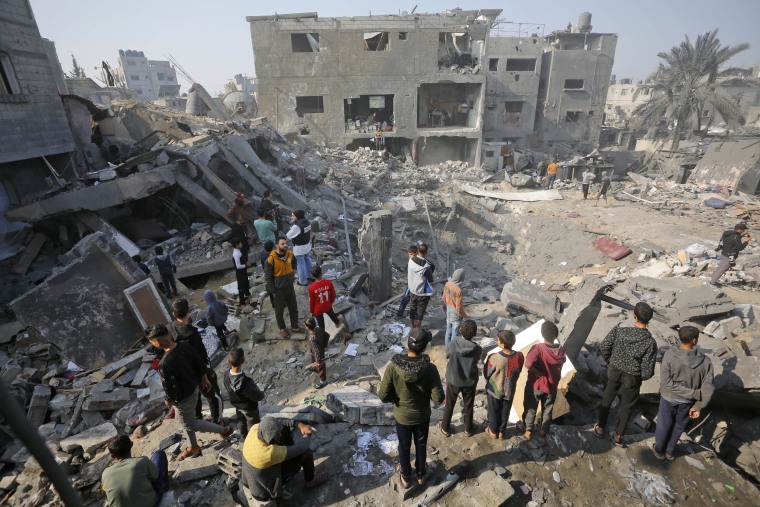 Residents search the rubble following an Israeli strike on the house belonging to Kistan family at the Nuseirat refugee camp in Deir al-Balah, central Gaza, on Dec. 18, 2023.