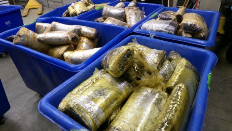 Bins filled with narcotics that were discovered in vats of jalapeño paste.  