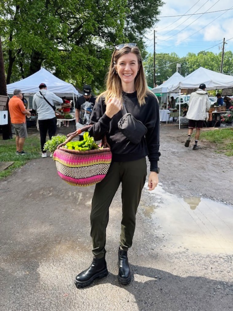 Kathryn Sisler holds a basket filled with vegetables.