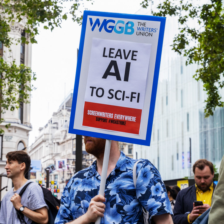 A supporter of UK performers' group Equity, holds a placard which reads "Leave AI To Sci-Fi" at a rally in solidarity with striking US actor collective SAG-AFTRA, in London