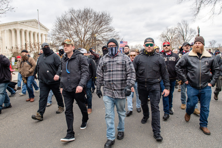 Charles Donohoe, right, with Proud Boys and Trump supporters  walk in front of the Capitol on Jan. 6, 2021. 
