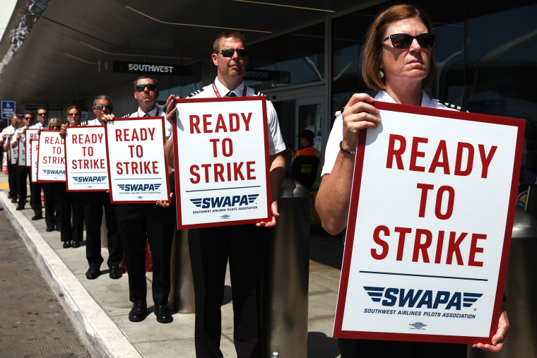 Southwest Airlines Pilots  hold "Ready to Strike" signs 