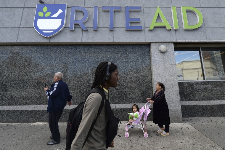 People walk past a Rite Aid in Queens, N.Y.