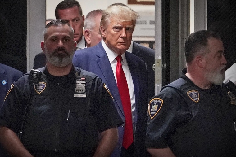 Former President Donald Trump is escorted to a courtroom in New York on April 4, 2023.