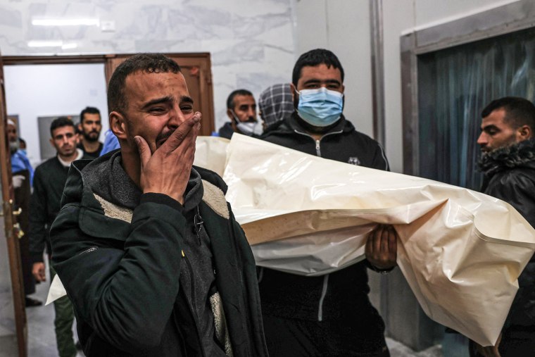 Mourners transport a body from the EU hospital in Khan Younis in the southern Gaza Strip on Dec. 21, 2023.