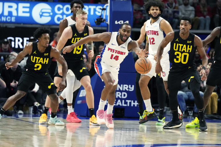 Detroit Pistons guard Alec Burks reaches for the loose ball an NBA basketball game.