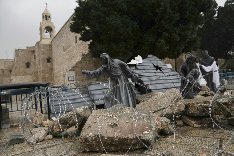 A nativity scene decorated to honor the victims in Gaza behind barbed wire.