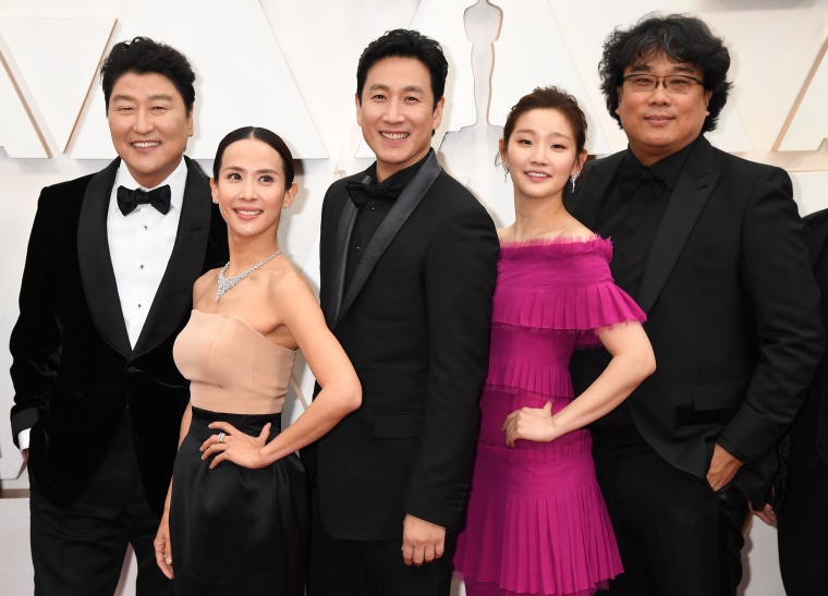 Lee, center, and director Bong Joon-ho, right, with the cast members of “Parasite” at the Academy Awards in 2020.
