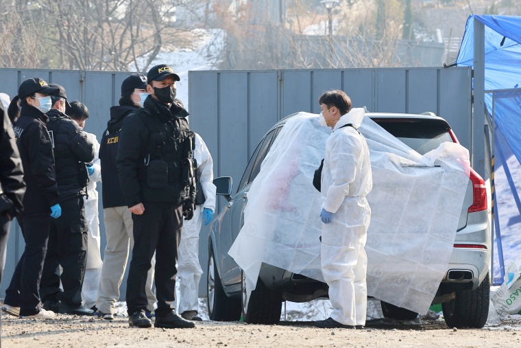 Investigators at the scene in Seoul, South Korea, where Lee was found dead Wednesday.