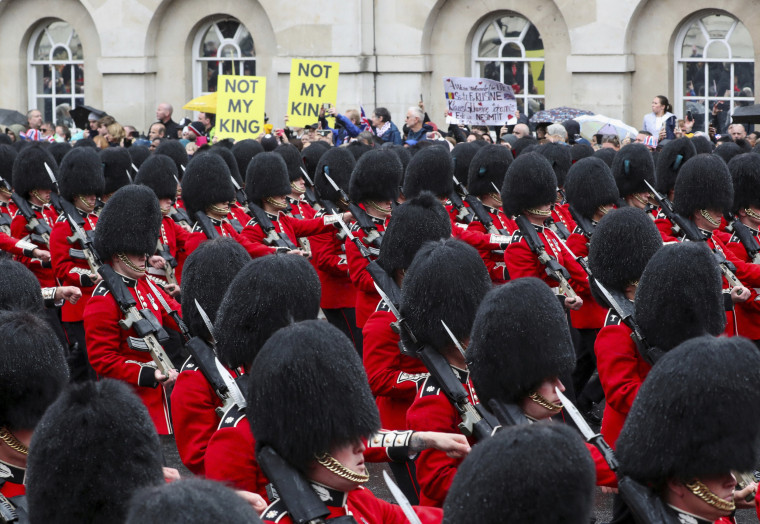 Grenadier Guards march past protesters during the coronation ceremony of King Charles III at Westminster Abbey on May 6, 2023.