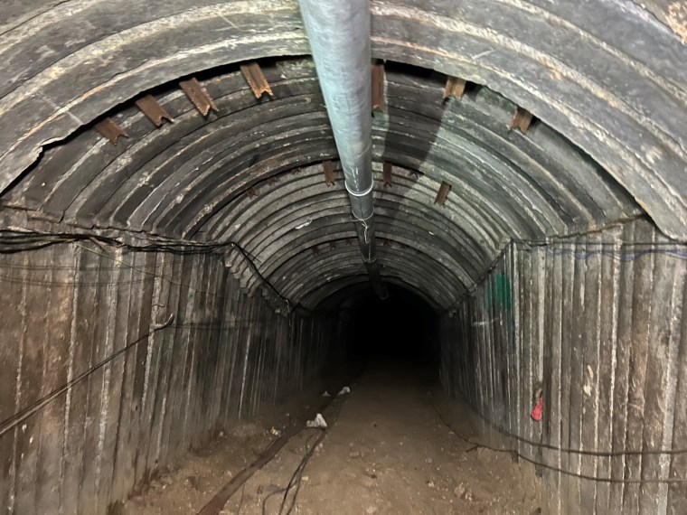 Although Israel’s military believes it has cleared any Hamas presence from the tunnel, troops with weapons drawn stand guard part of the way inside. 