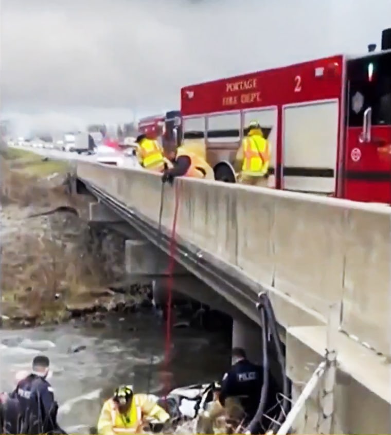 Members of Portage Fire Dept. help rescue a driver who was stuck in his mangled car in a creek off of I-94 for days.
