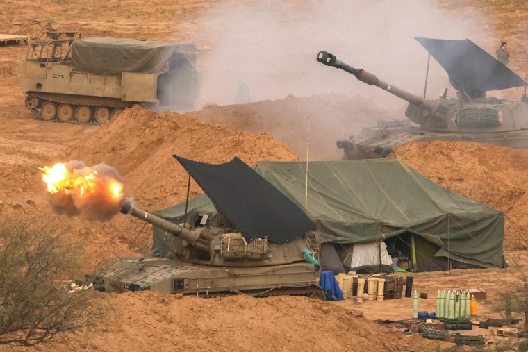 An Israeli army self-propelled artillery howitzer fires rounds from a position near the border with the Gaza Strip in southern Israel