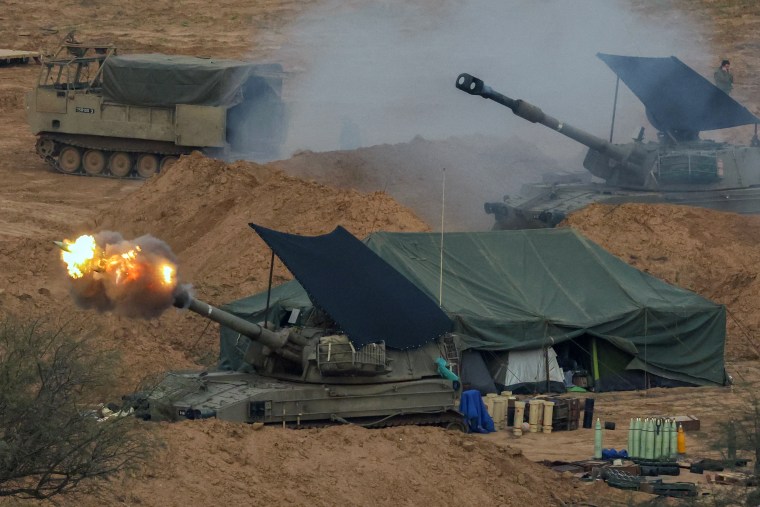 Image: An Israeli army self-propelled artillery howitzer fires rounds 