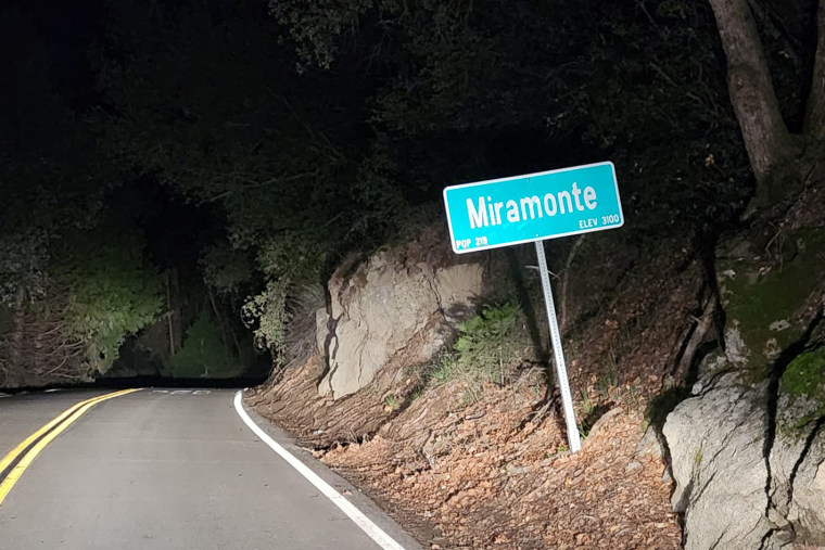 Miramonte sign by a road at night.