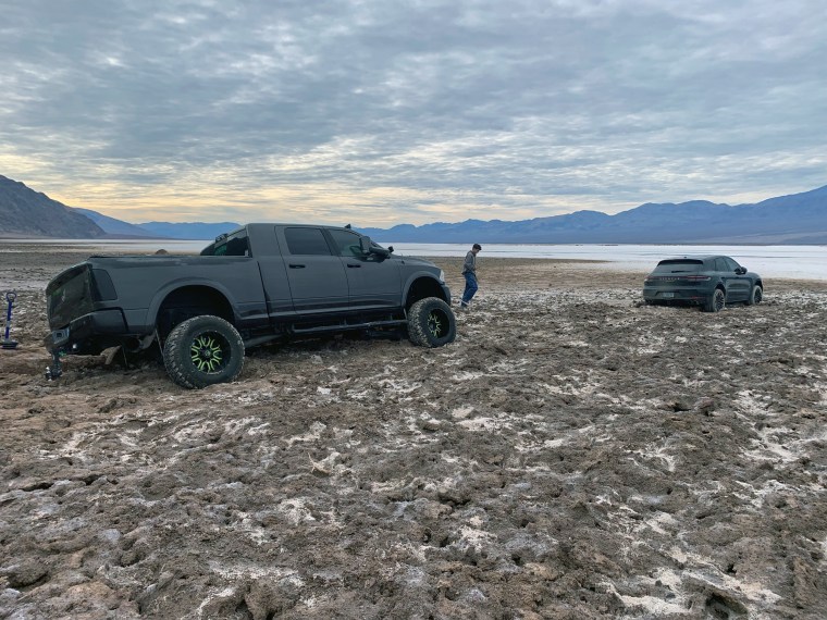 A Porsche and its attempted rescuer stuck south of Badwater Basin.