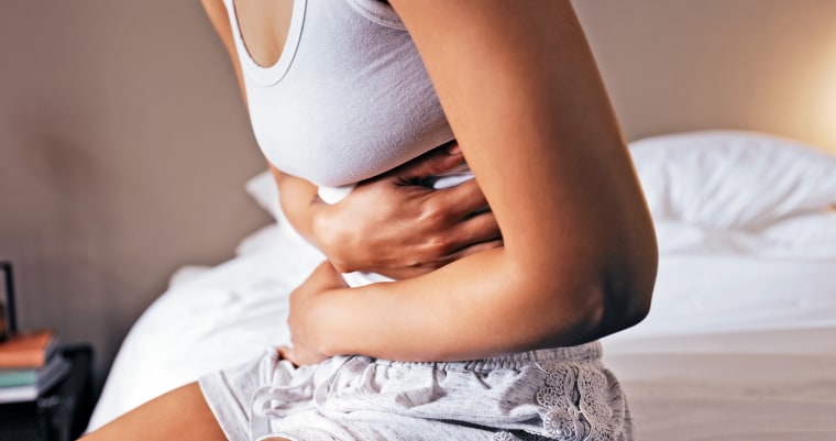 Woman clutching stomach in pain