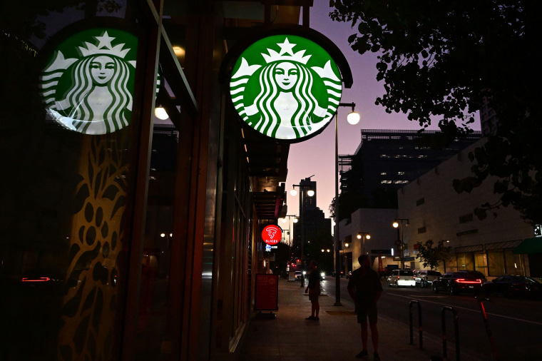 People stand outside a Starbucks in Los Angeles in 2022.