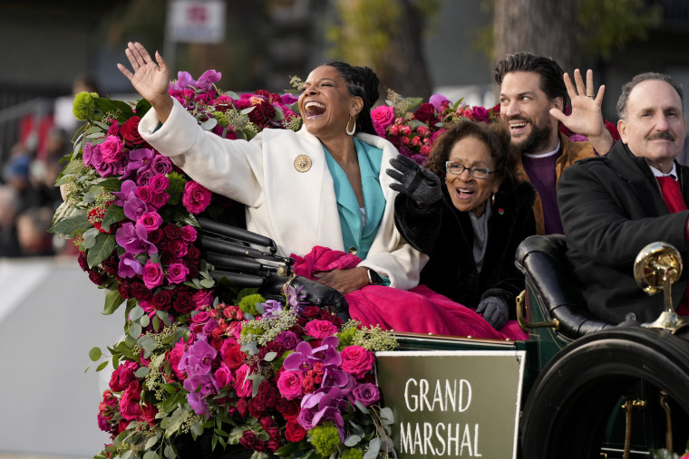 Grand Marshal Audra McDonald, left, waves to the crowd.