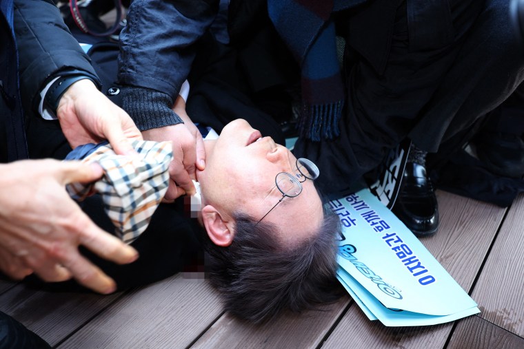 South Korean opposition party leader Lee Jae-myung is attended to after being attacked in Busan on January 2, 2024