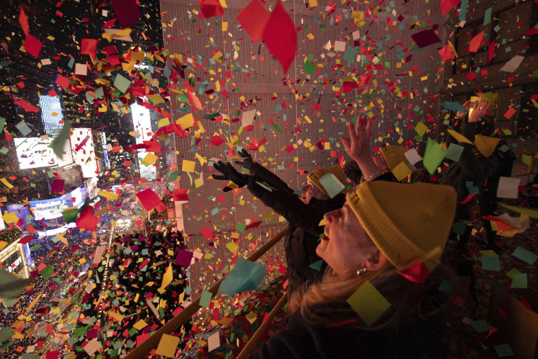 Times Square Alliance volunteers throw confetti as the clock strikes midnight as seen from the New York Marriott Marquis during the New Year's Eve celebration in Times Square, Monday, Jan. 1, 2024, in New York.