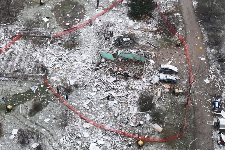 Aerial view of the destroyed home surrounded by debris.