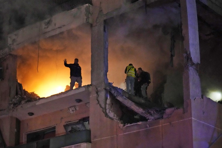 Civil defence workers search for survivors inside an apartment following a massive explosion in the southern suburb of Beirut, Lebanon, Jan. 2, 2024.