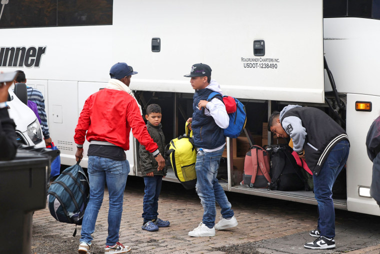 A group of migrants arrive by bus near a Greyhound station in Chicago after being transported from Texas on Oct. 25, 2023.