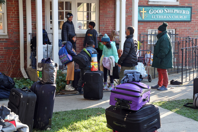 Migrants and their belongings outside Good Shepherd Lutheran Church in Oak Park, Ill, on Nov. 1, 2023, where they were being given shelter.