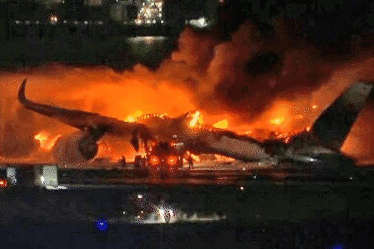 A passenger plane burst into flames as it landed at a Tokyo airport.