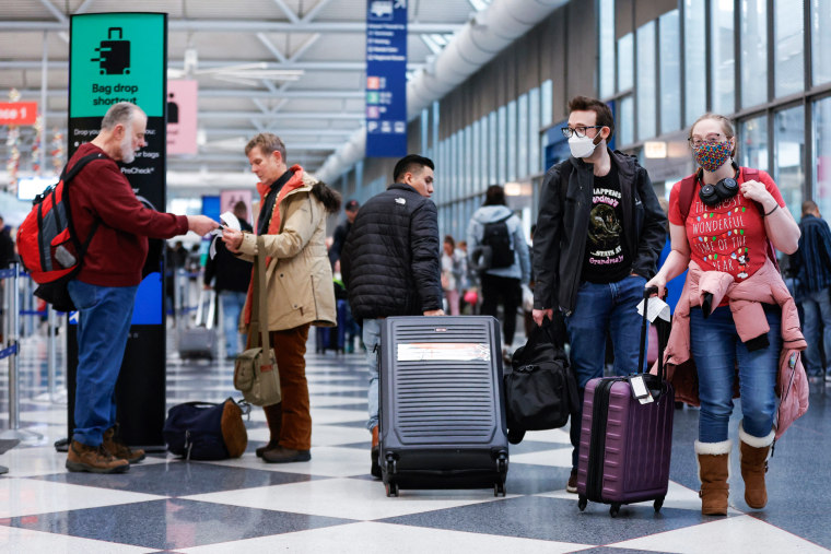 Travelers walk through Chicago O'Hare International Airport.