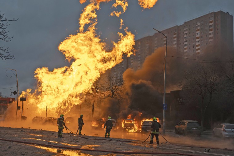Firefighters work to extinguish a fire after a Russian attack in Kyiv, Ukraine, Tuesday, Jan. 2, 2024. 