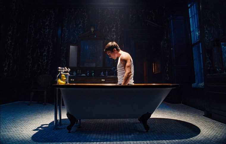 Barry Keoghan stands in a bathtub in "Saltburn."