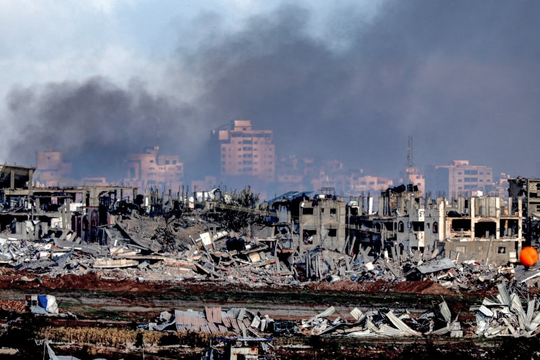 Buildings destroyed by Israeli bombardment in the central Gaza Strip from a position across the border in southern Israel on Jan. 3, 2024.