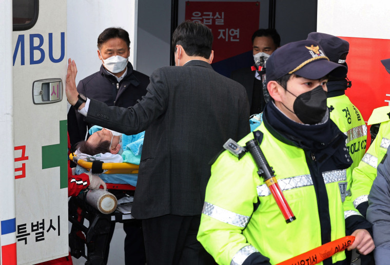 South Korean opposition party leader Lee Jae-myung, who was attacked in Busan, lies on a stretcher as he arrives at Seoul National University Hospital in Seoul on Jan. 2, 2024. 