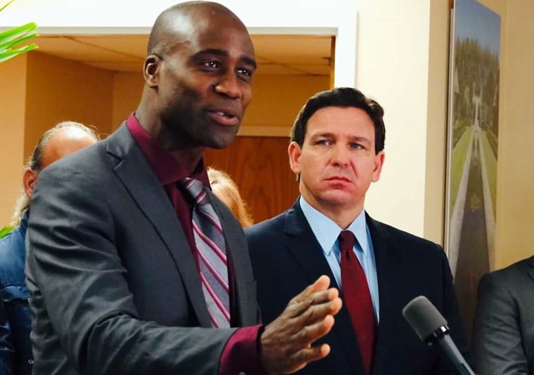 Joseph Ladapo and Ron DeSantis at a news conference in West Palm Beach, Fla.,