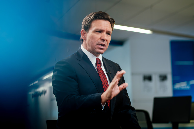 Ron DeSantis speaks with reporters during an interview in Des Moines, Iowa.