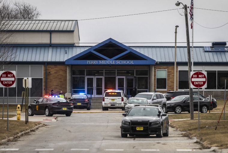 Image: Police officers secure the campus at Perry Middle and High School
