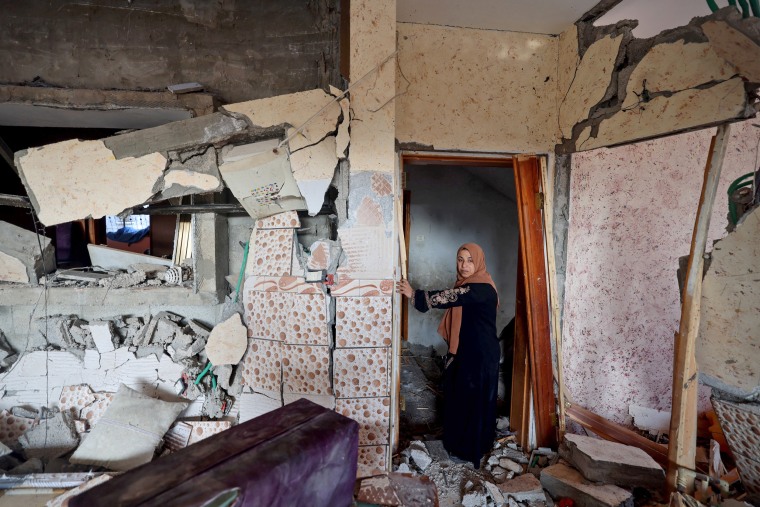 A woman stands in her damaged house in Rafah in the southern Gaza Strip on Jan. 5, 2024.