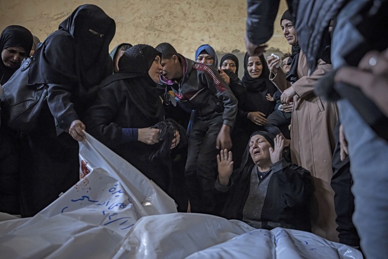 Members of the Abu Sinjar family mourn their relatives in Rafah, southern Gaza, Friday, Jan. 5, 2024. 