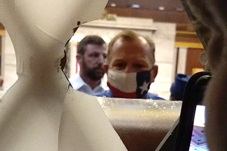 Troy Nehls, center, and Markwayne Mullin, speaking with Capitol rioters trying to breach the main door into the chamber of the U.S. House of Representatives.