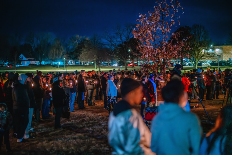 Community members gather Thursday at a candlelight vigil at Wiese Park to reflect on and mourn the shooting at the Perry Middle School and High School complex in Perry, Iowa. 