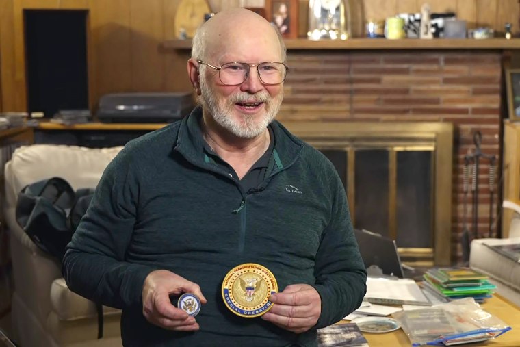 Bob Sauer shows off a patch and medallion he received from the National Transportation Safety Board on Monday.