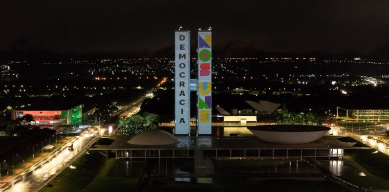 The phrase "Democracy Unites Us" is promected on the Brazilian National Congress building in Brasilia on Jan. 7, 2024.