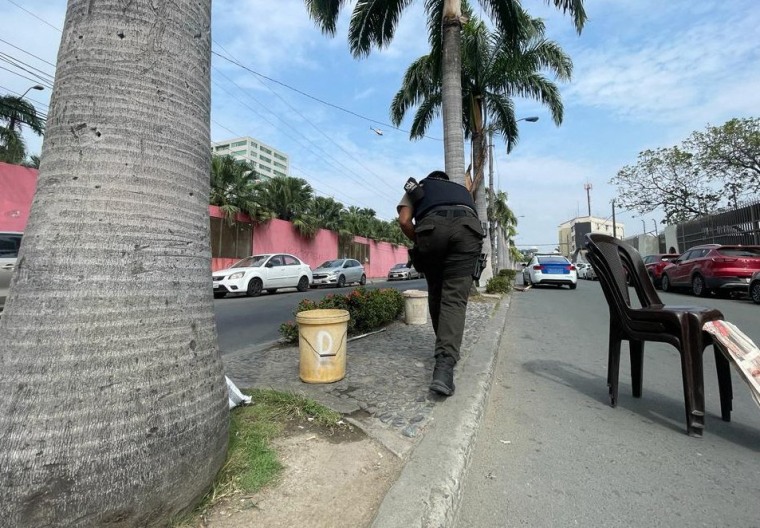 An Ecuadorean policeman approaches the premises of Ecuador's TC television channel after unidentified gunmen burst into the state-owned television studio live on air on January 9, 2024, in Guayaquil. 
