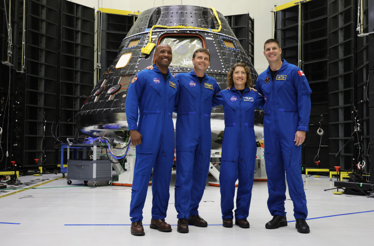 From left, astronauts Victor Glover, Reid Wiseman, Christina Hammock Koch and Jeremy Hansen in front of the Artemis II Crew Module at Kennedy Space Center
