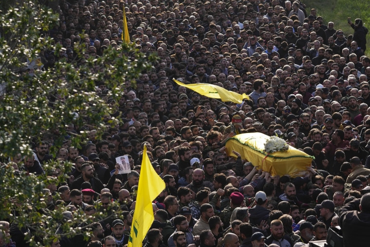 Mourners carry the coffin of senior Hezbollah commander Wissam Tawil, during his funeral procession in the village of Khirbet Selm, south Lebanon, on Jan. 9, 2024. 