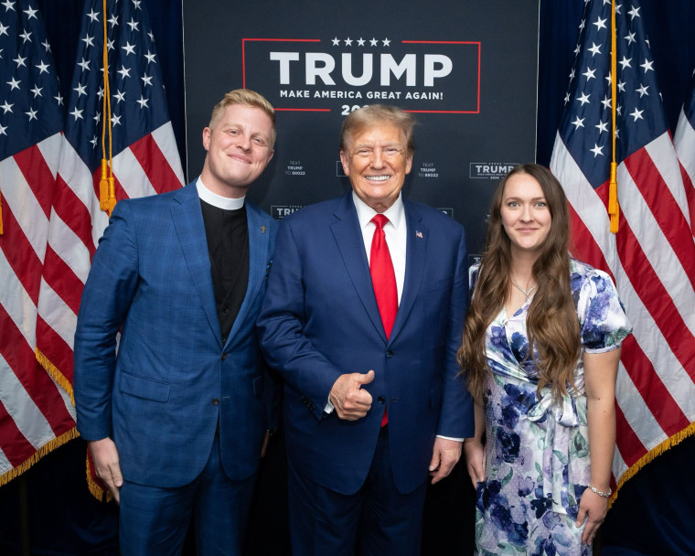 The Rev. Joel Tenney, pictured here with his wife Sarah and Trump, prayed at a December rally in Coralville, Iowa.